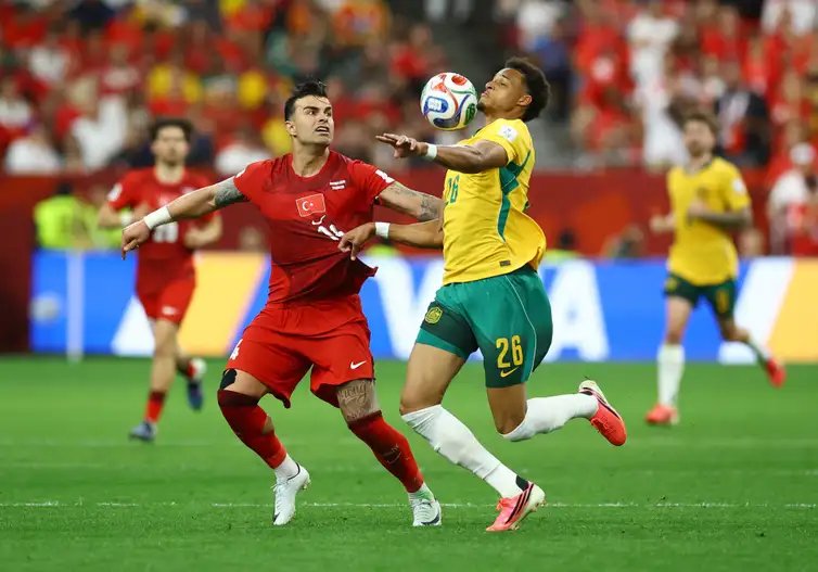 Soccer Football - FIFA World Cup 2026 - Group D - Australia v Turkey - BC Place, Vancouver, Canada - June 13, 2026 Australia's Tete Yengi in action with Turkey's Abdulkerim Bardakci REUTERS/Albert Gea