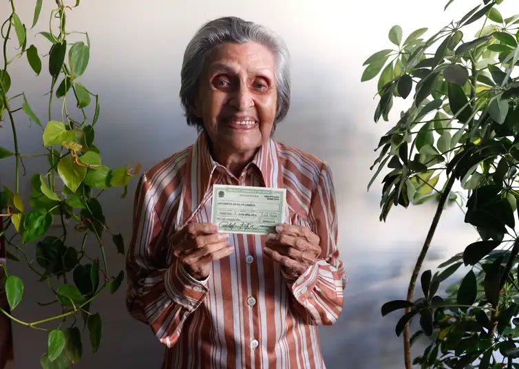 Rio de Janeiro (RJ), 10/07/2026 - Antonieta da Silva Campos, 96 anos, bancária aposentada, exibe seu título de eleitor em sua casa. Foto: Tânia Rêgo/Agência Brasil